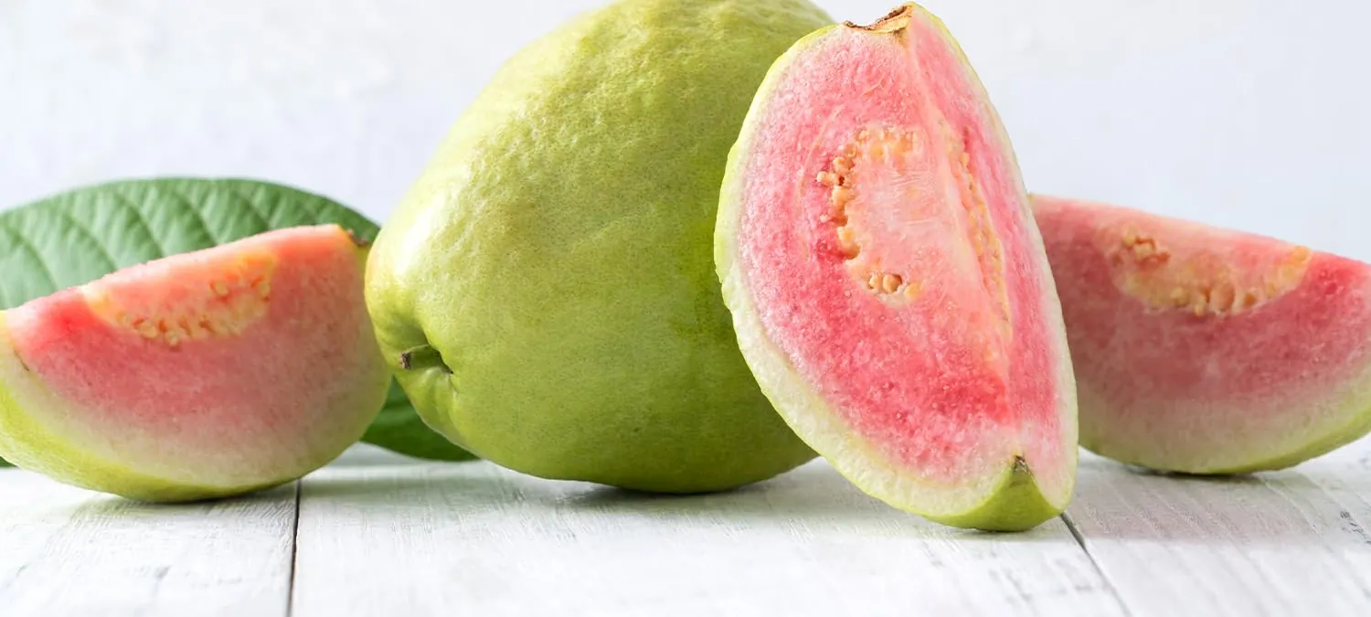 Whole and halved pink guava